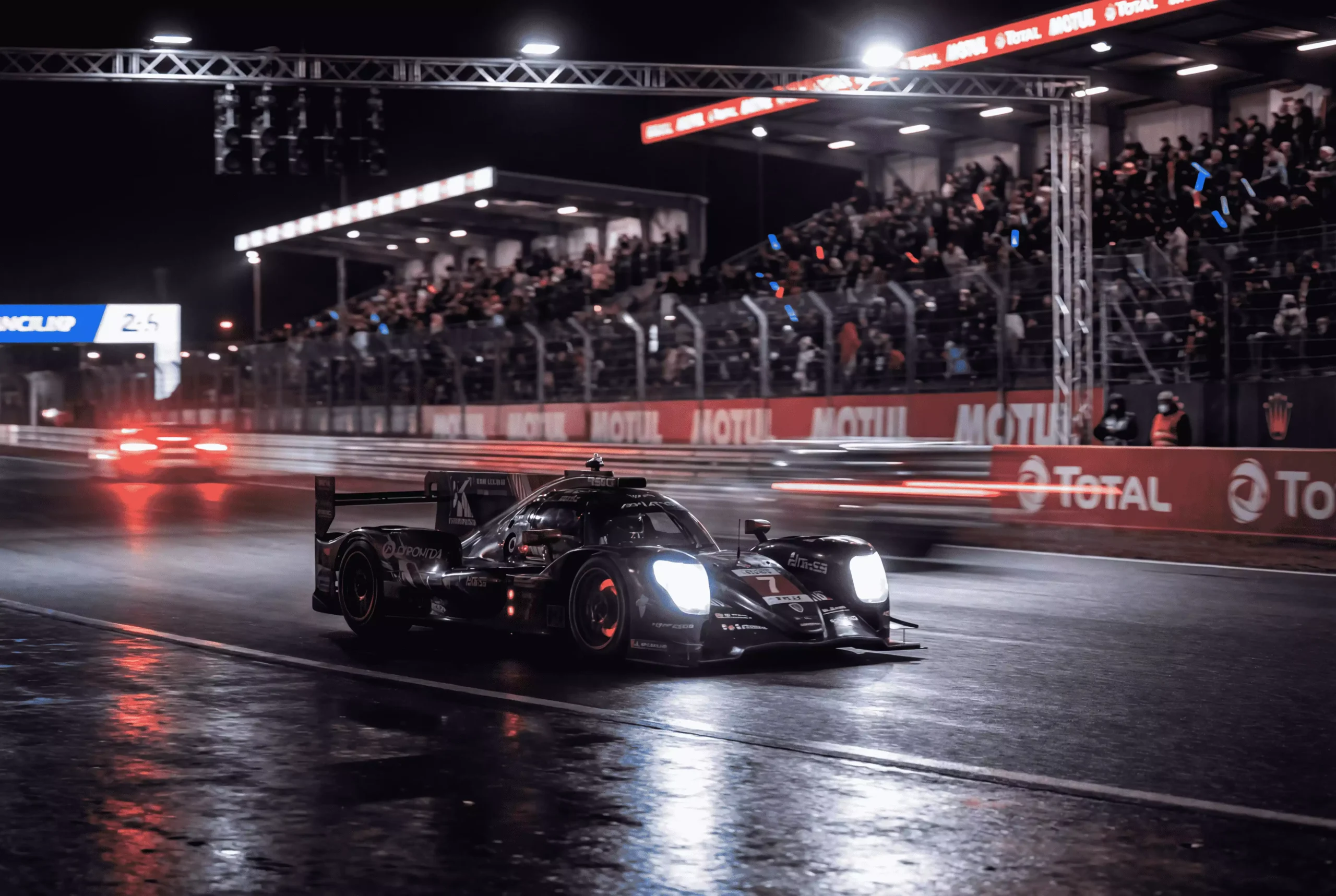 Sportwagen auf der Rennstrecke von Le Mans während der Nachtphase des 24-Stunden-Rennens